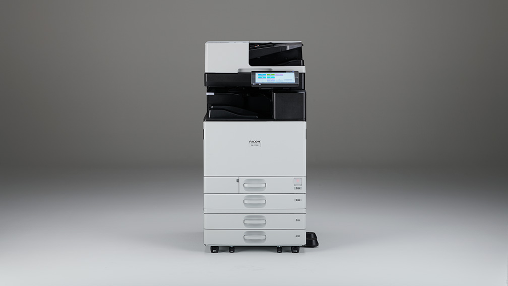 Ricoh multifunction printer on a plain backdrop, showcasing Woodhull, LLC’s reliable and high-performance office technology solutions for modern businesses.