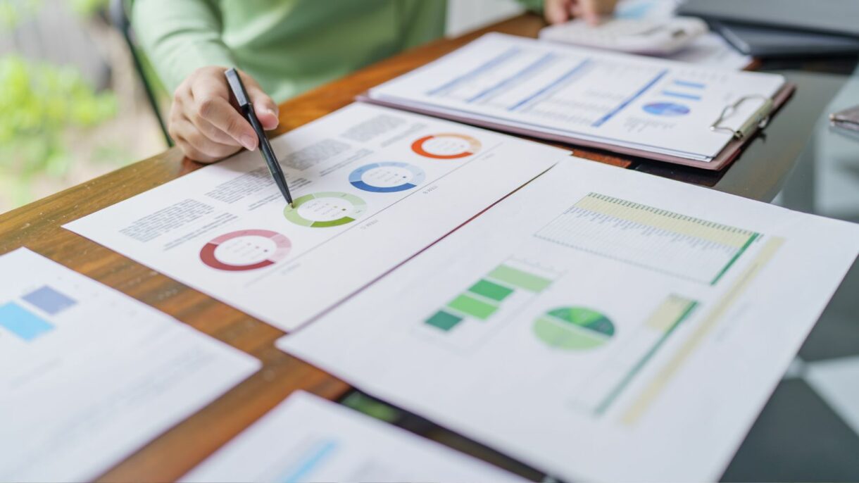 Business professional analyzing data charts and graphs, emphasizing Woodhull’s expertise in optimizing document workflows and data management for increased productivity.